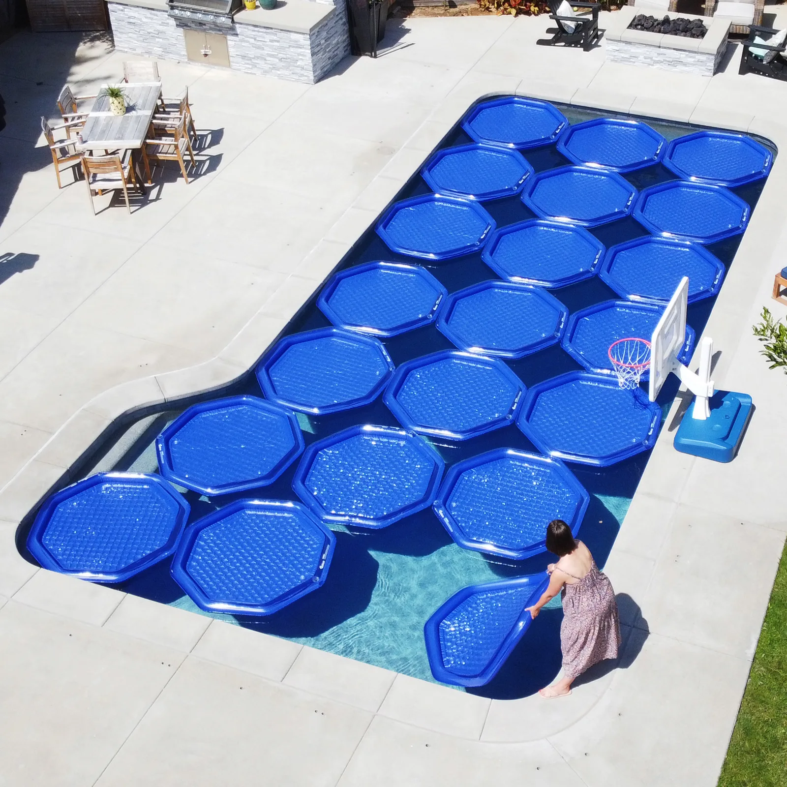 Floating solar heaters covering an inground pool, seen from above