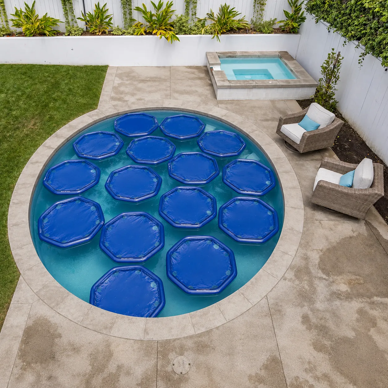 Round above ground pool with floating solar heaters on the water